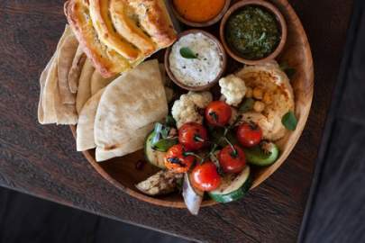 Mediterranean platter with classic hummus, Tides roasted red pepper hummus or tzatziki